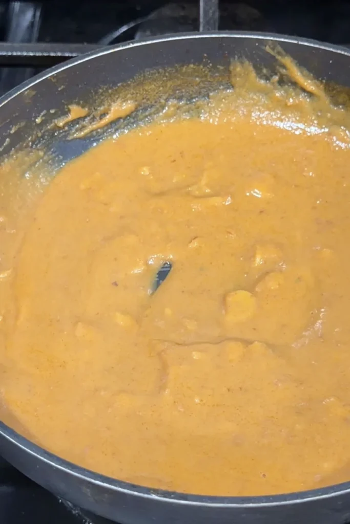 Kare kare sauce simmering in a pan until smooth and creamy.
