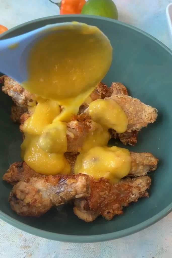 Mango habanero sauce poured over crispy air fryer chicken wings.