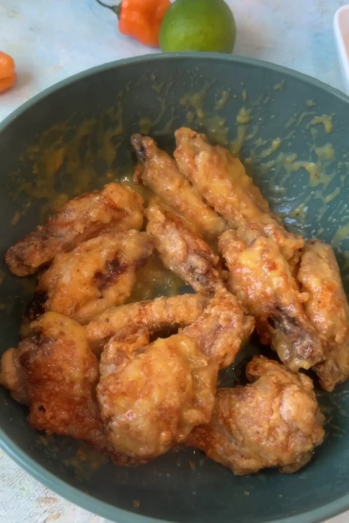 Air fryer chicken wings tossed in mango habanero sauce until coated.