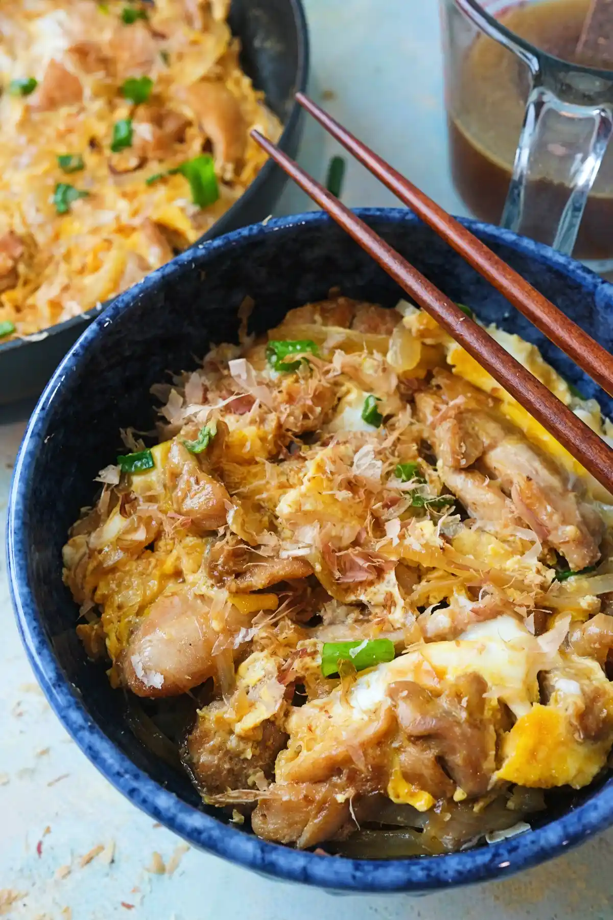 Detailed view of oyakodon showing soft eggs, tender chicken, and sauce-coated onions in a bowl.