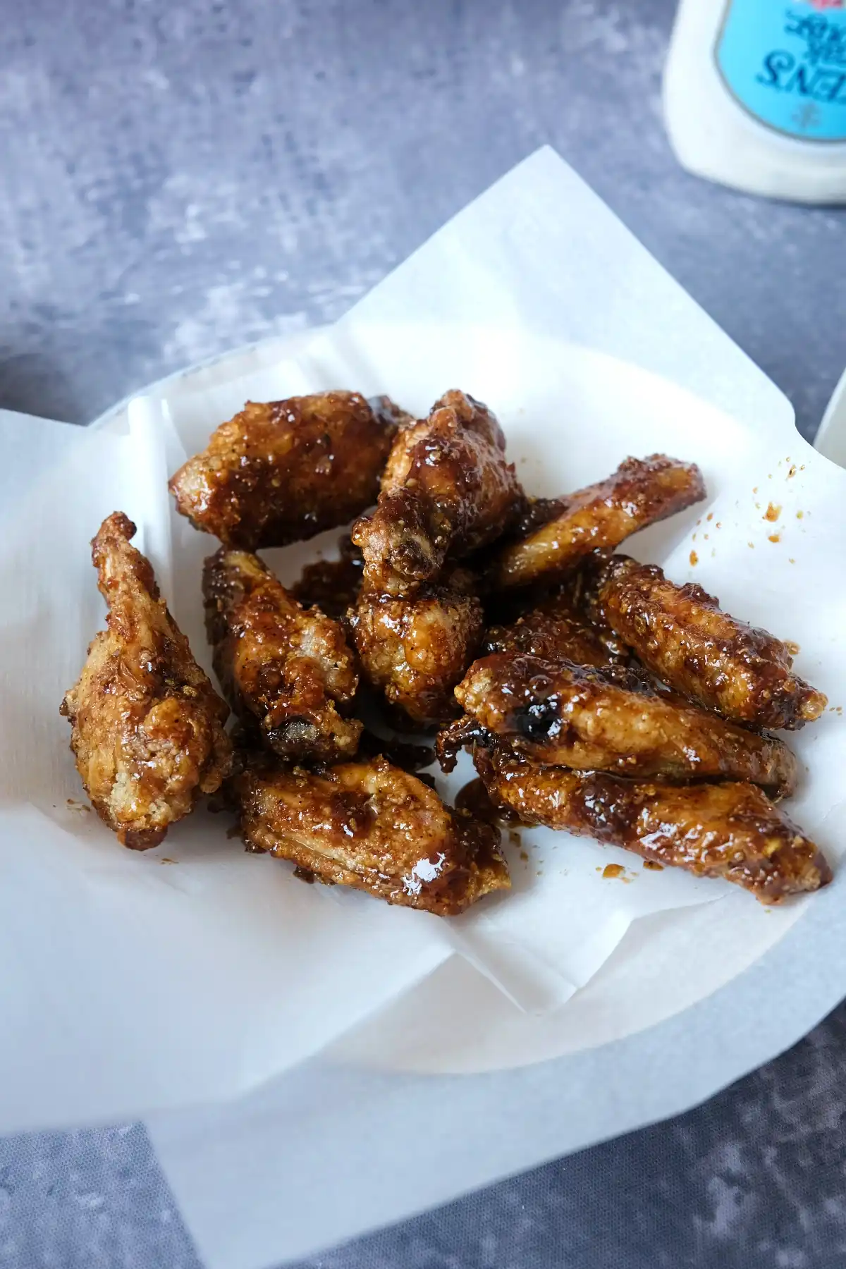 Sticky soy garlic chicken wings with crispy edges served with creamy ranch dip.