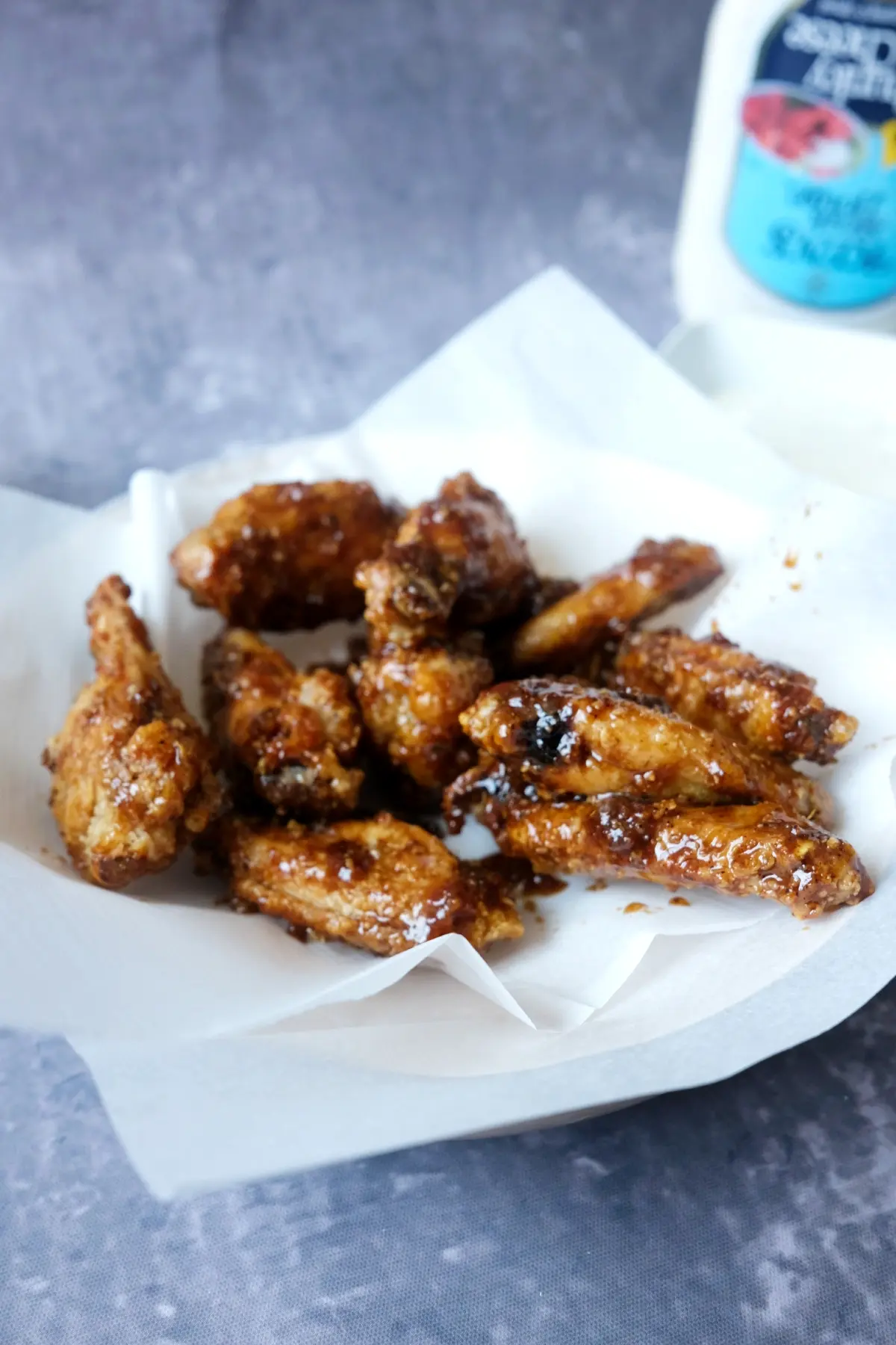 Close-up of crispy Korean-style soy garlic wings with caramelized garlic glaze.