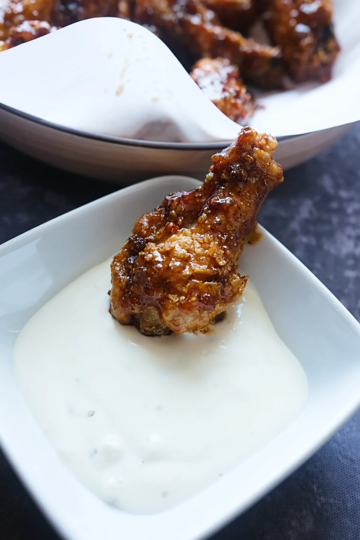 Crispy soy garlic wing dipped into creamy ranch dressing.