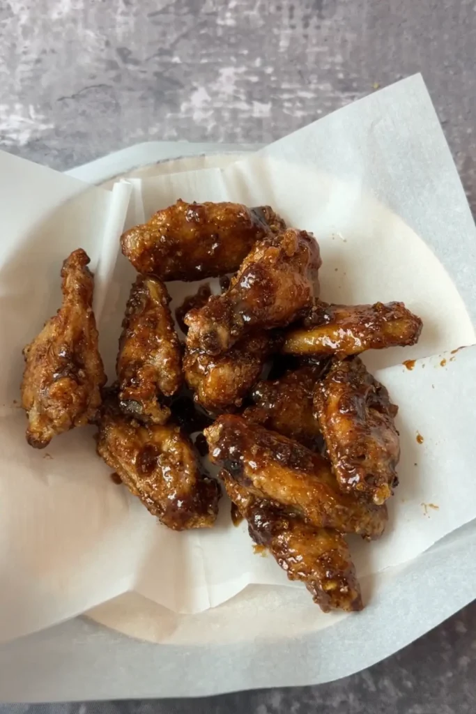 Crispy Korean-style soy garlic chicken wings with sticky garlic glaze served hot.