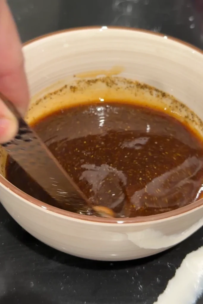 Soy garlic wing sauce mixture being whisked together in a bowl before cooking