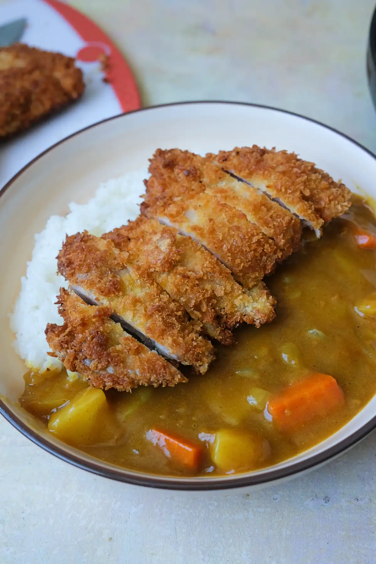 Chicken katsu sliced and served over steamed rice with Japanese curry sauce.