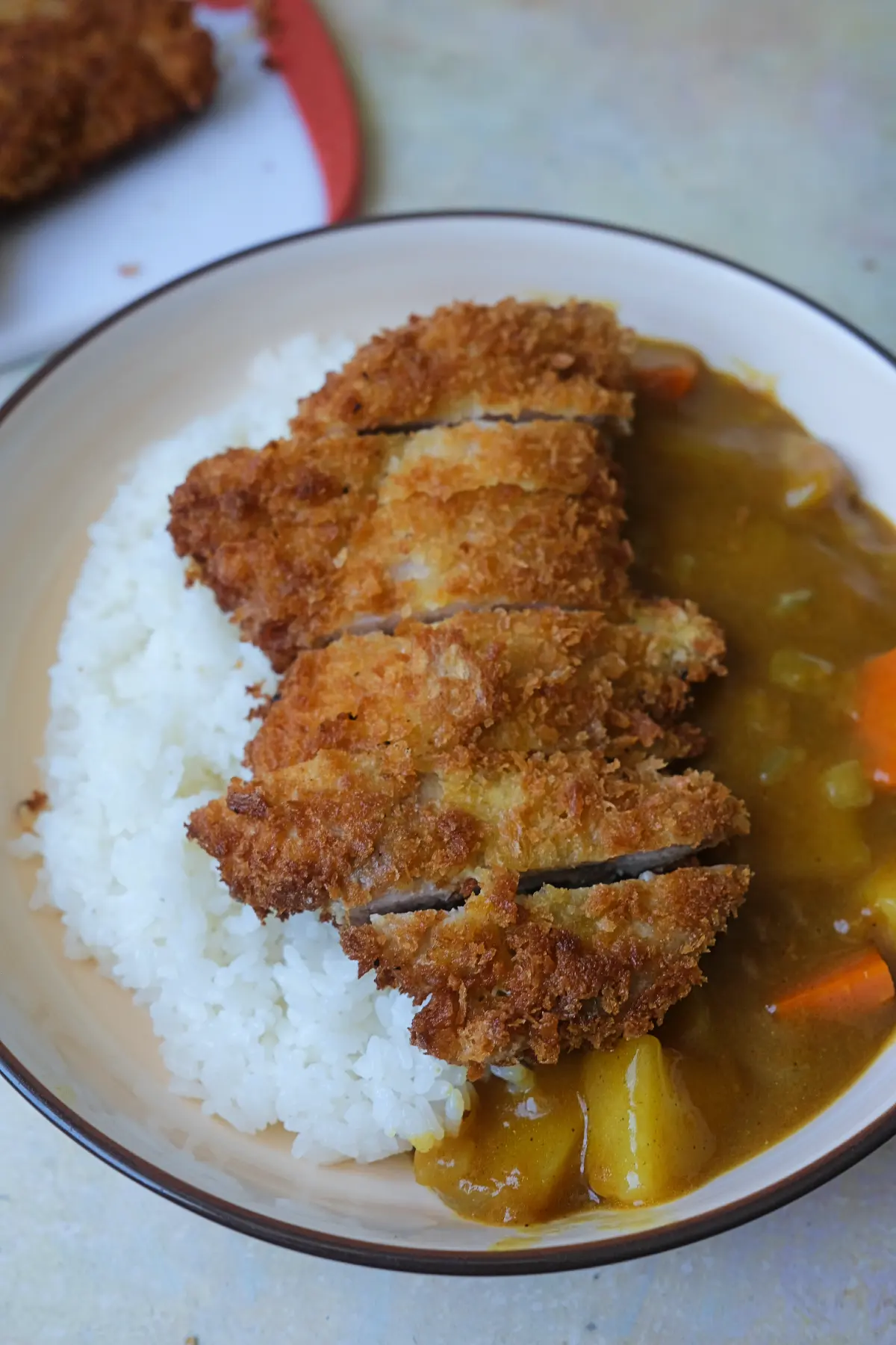 Chicken katsu curry served with fluffy white rice and chunky vegetable curry.