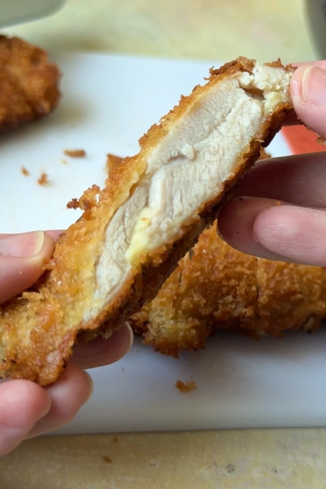 Close-up of crispy chicken katsu showing the juicy chicken inside and golden panko breadcrumb coating.