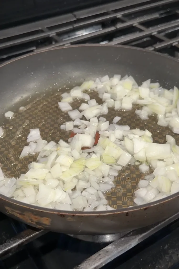 Diced onions sautéing in oil for homemade Japanese curry sauce.