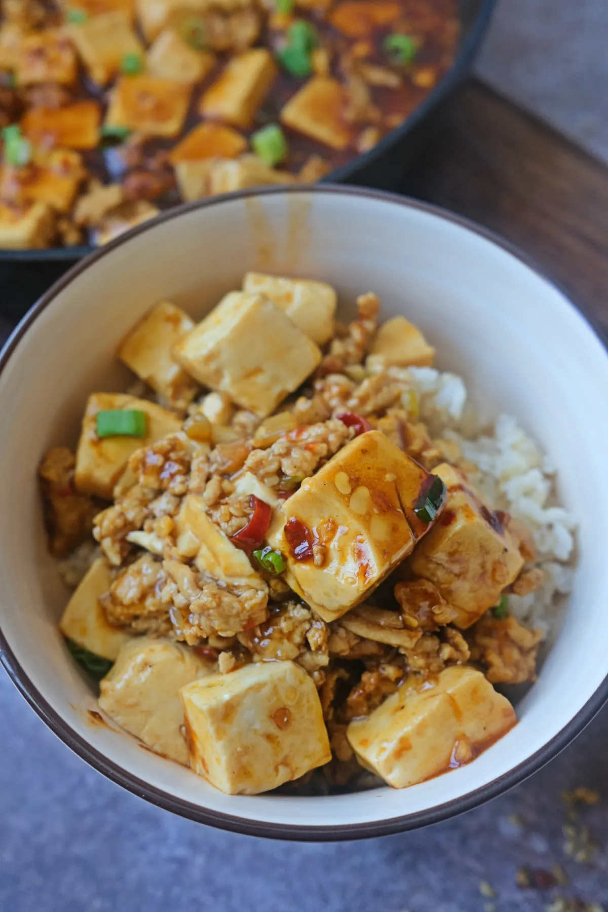 Chicken mapo tofu rice bowl topped with silky tofu, ground chicken, and spicy Sichuan sauce.
