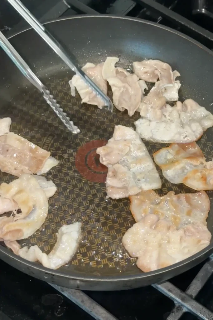 Pork belly lightly browned in a skillet before adding to Japanese curry broth