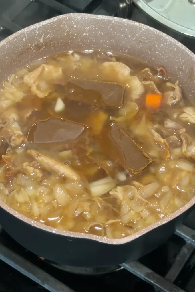 Adding Japanese curry roux cubes to the simmering curry udon broth