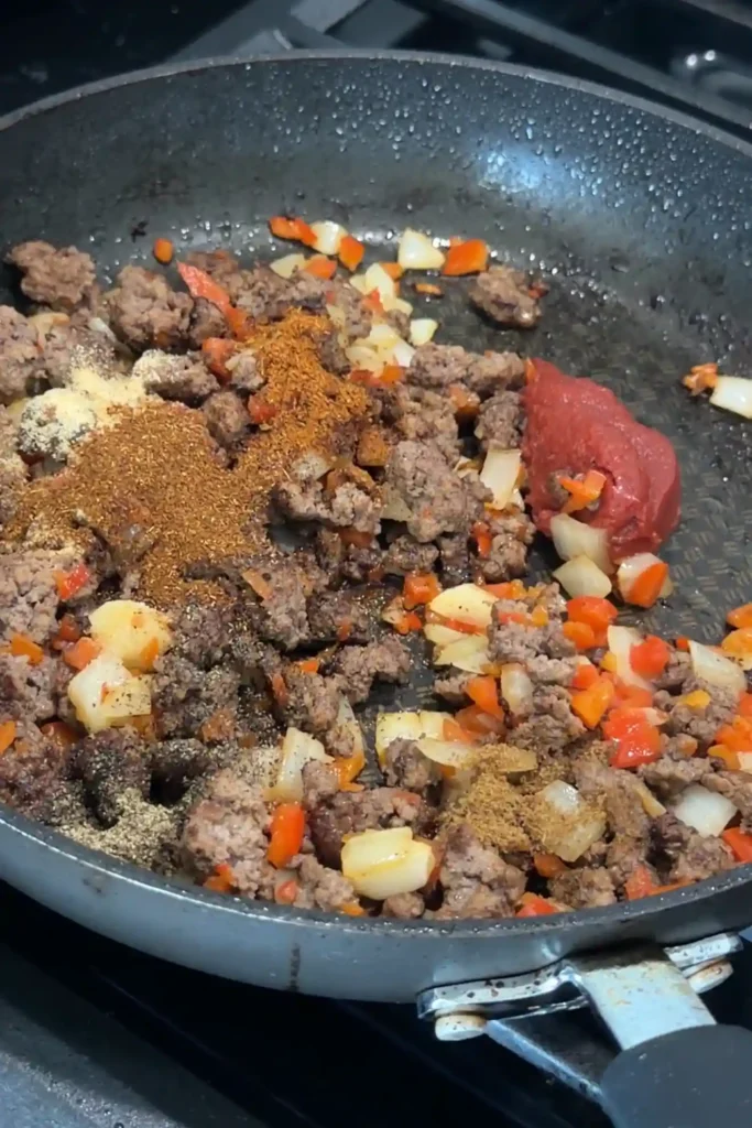 Ground beef mixed with tomato paste and spices for cheesy beef quesadilla filling.
