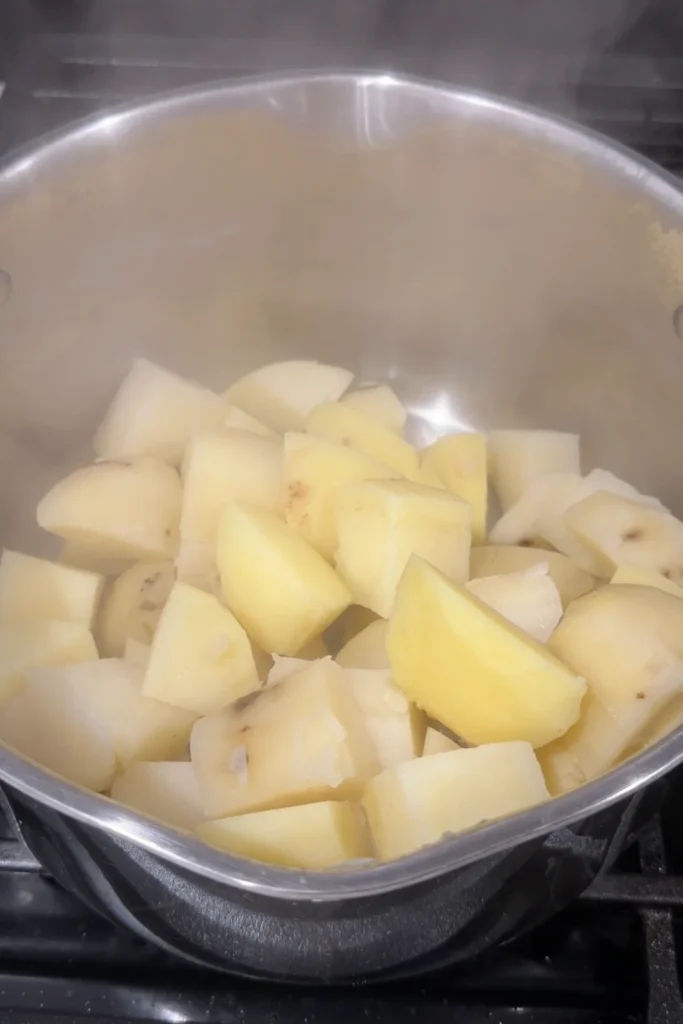 Cooked potatoes drained and ready to be mashed.