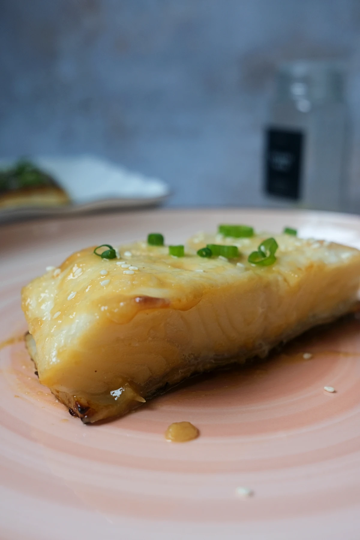 Air fryer miso glazed Chilean sea bass garnished with sesame seeds and green onions
