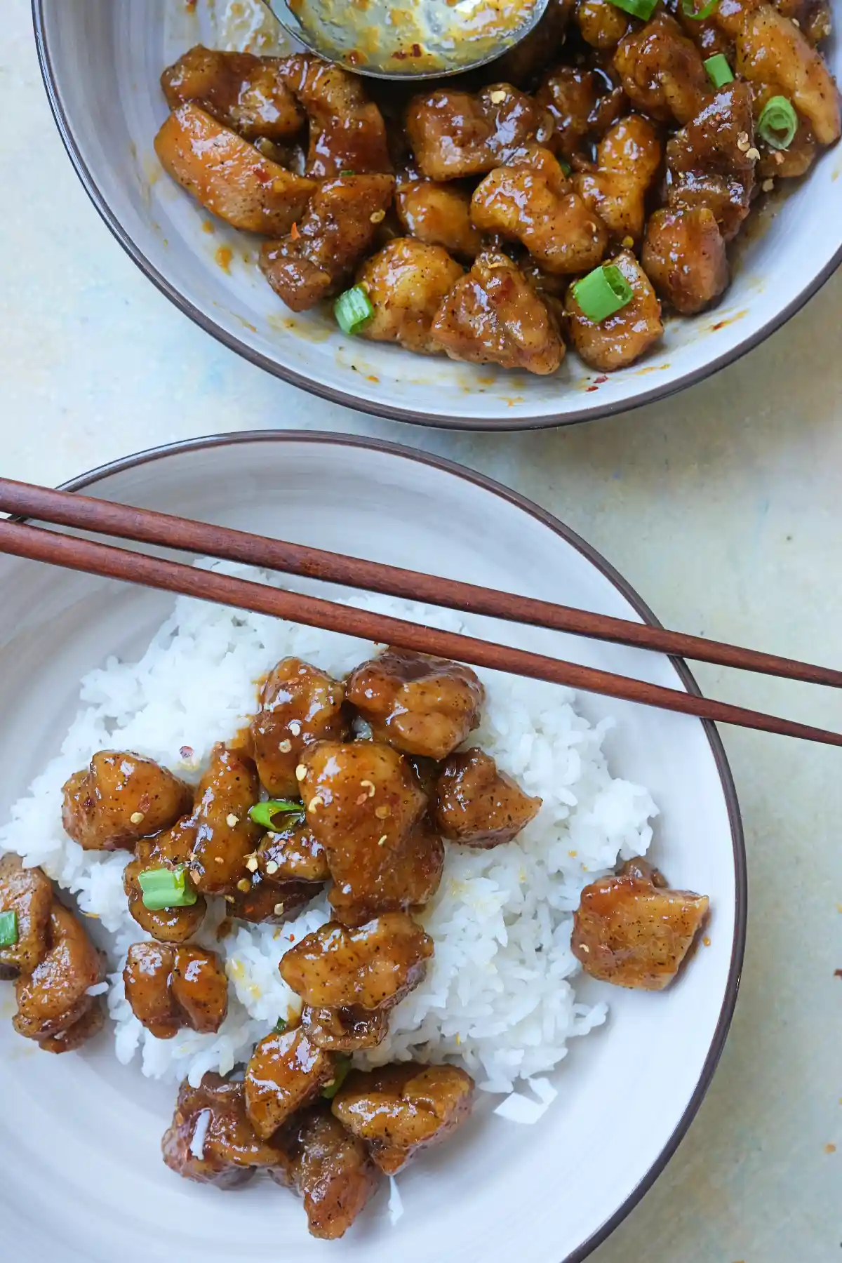 Homemade Hot Orange Chicken over steamed white rice with a sweet and spicy orange glaze.