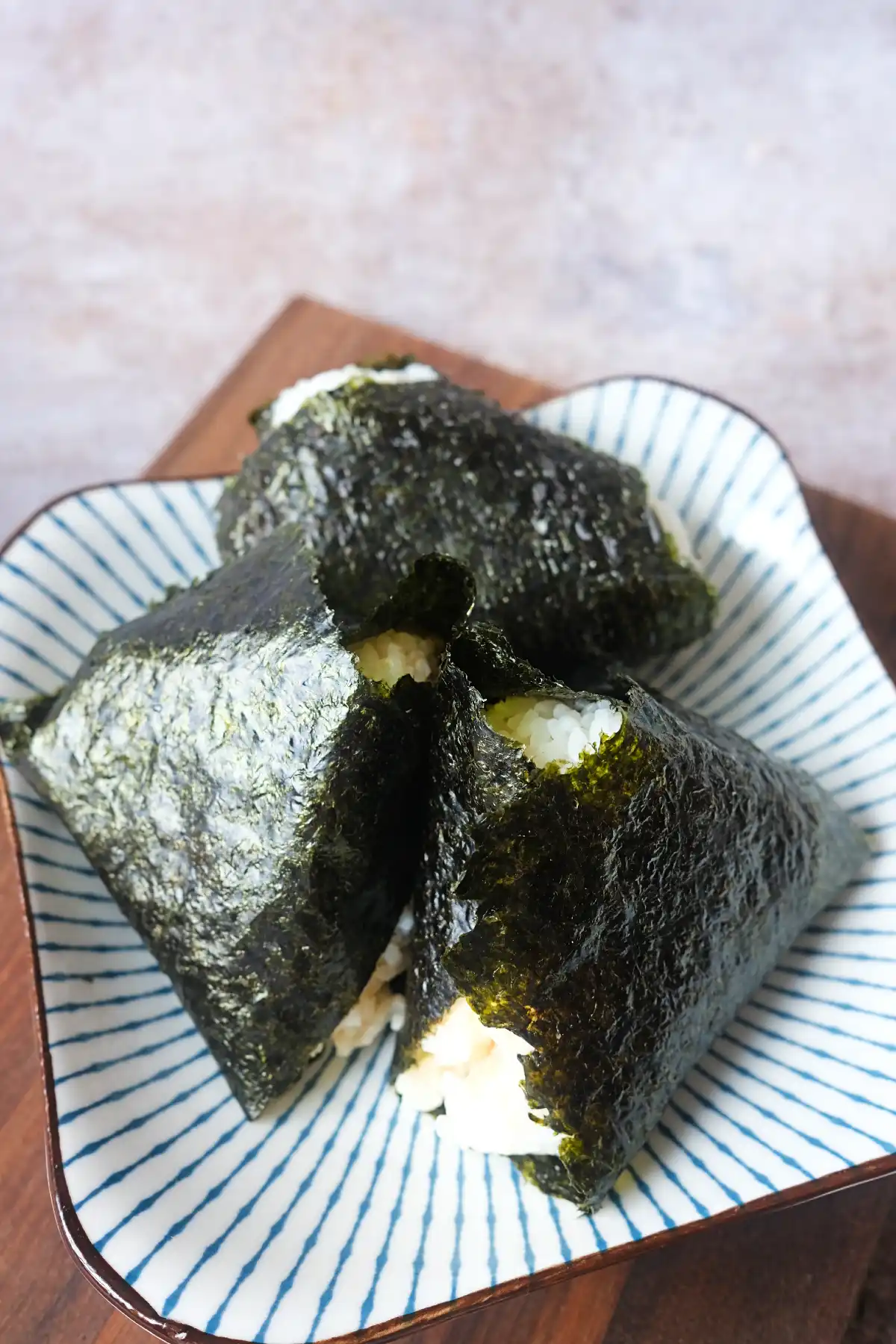 Homemade salmon onigiri made with seasoned rice, spicy salmon filling, and crisp nori wrapper