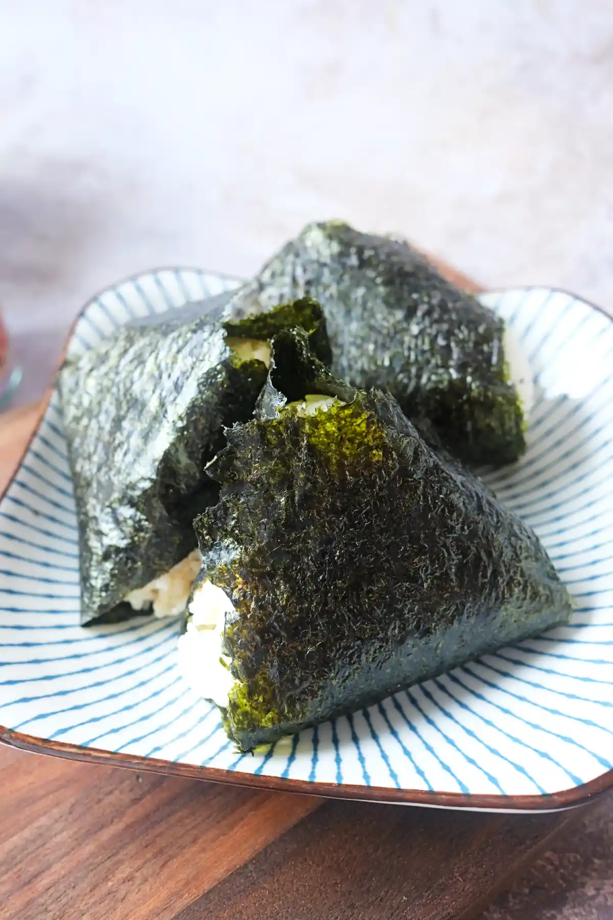 Japanese salmon onigiri rice balls served on a plate wrapped in seaweed for an easy grab-and-go snack