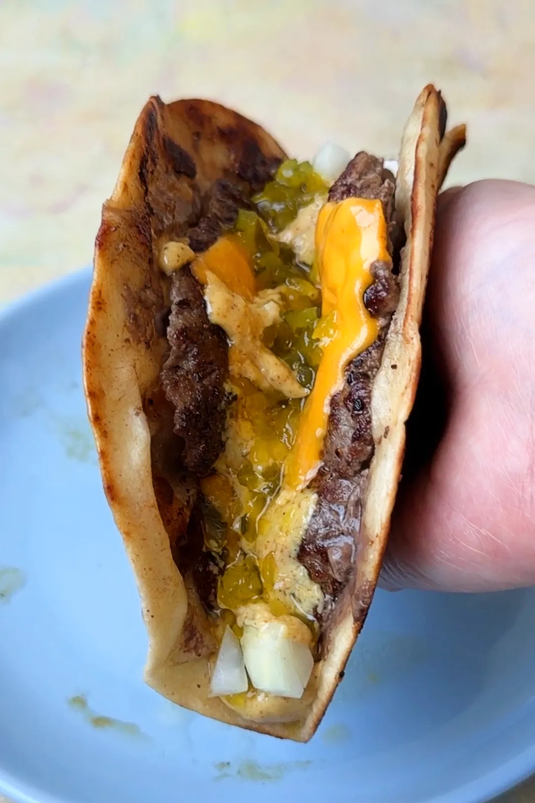 Hand holdling a Smash burger taco 