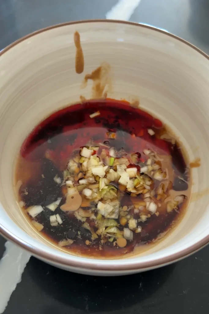 Sesame paste mixture made with sesame paste, soy sauce, chili oil, vinegar, and green onions for tantanmen