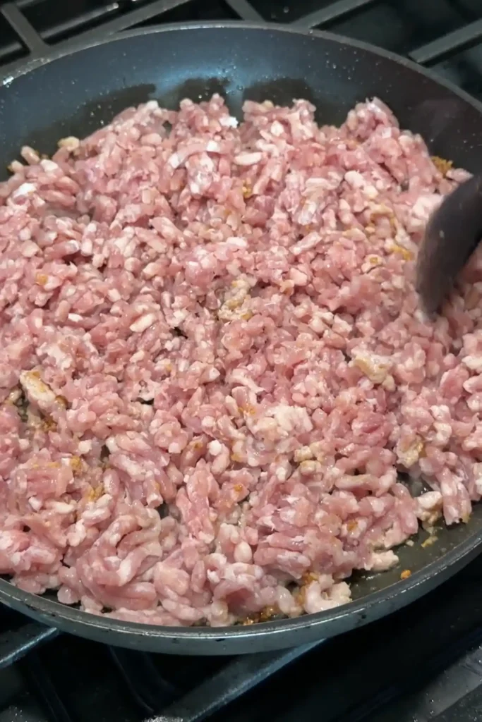Ground pork cooking in a skillet for tantanmen ramen topping