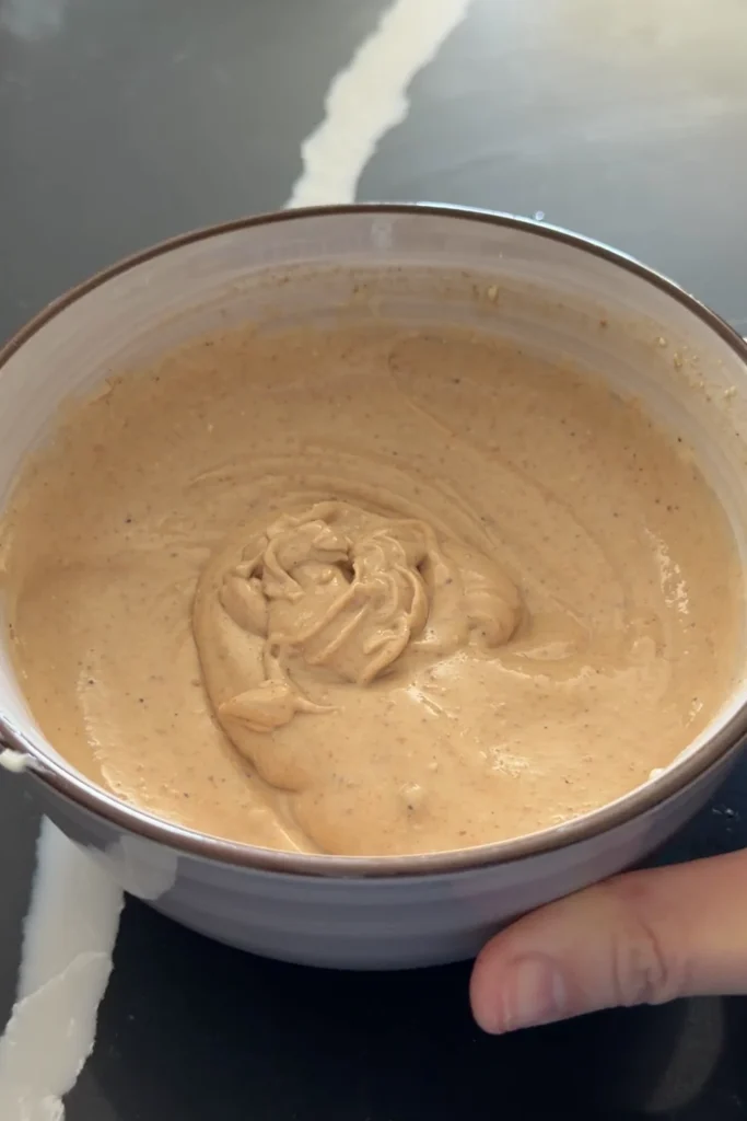 Creamy sisig sauce mixed until smooth in a bowl.