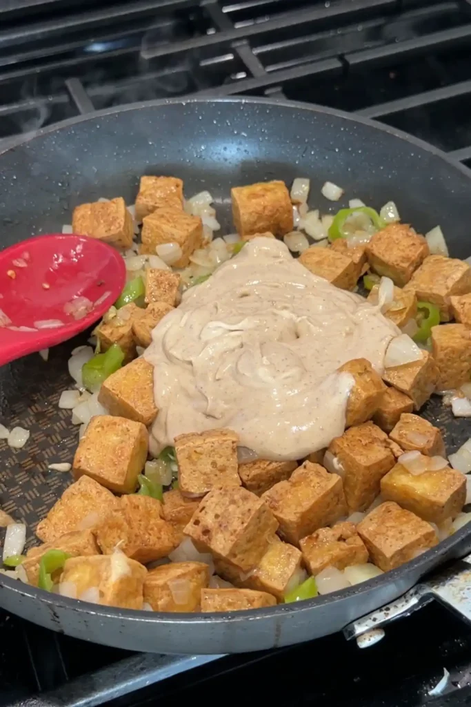 Creamy sisig sauce poured over crispy tofu, onions, and chiles.