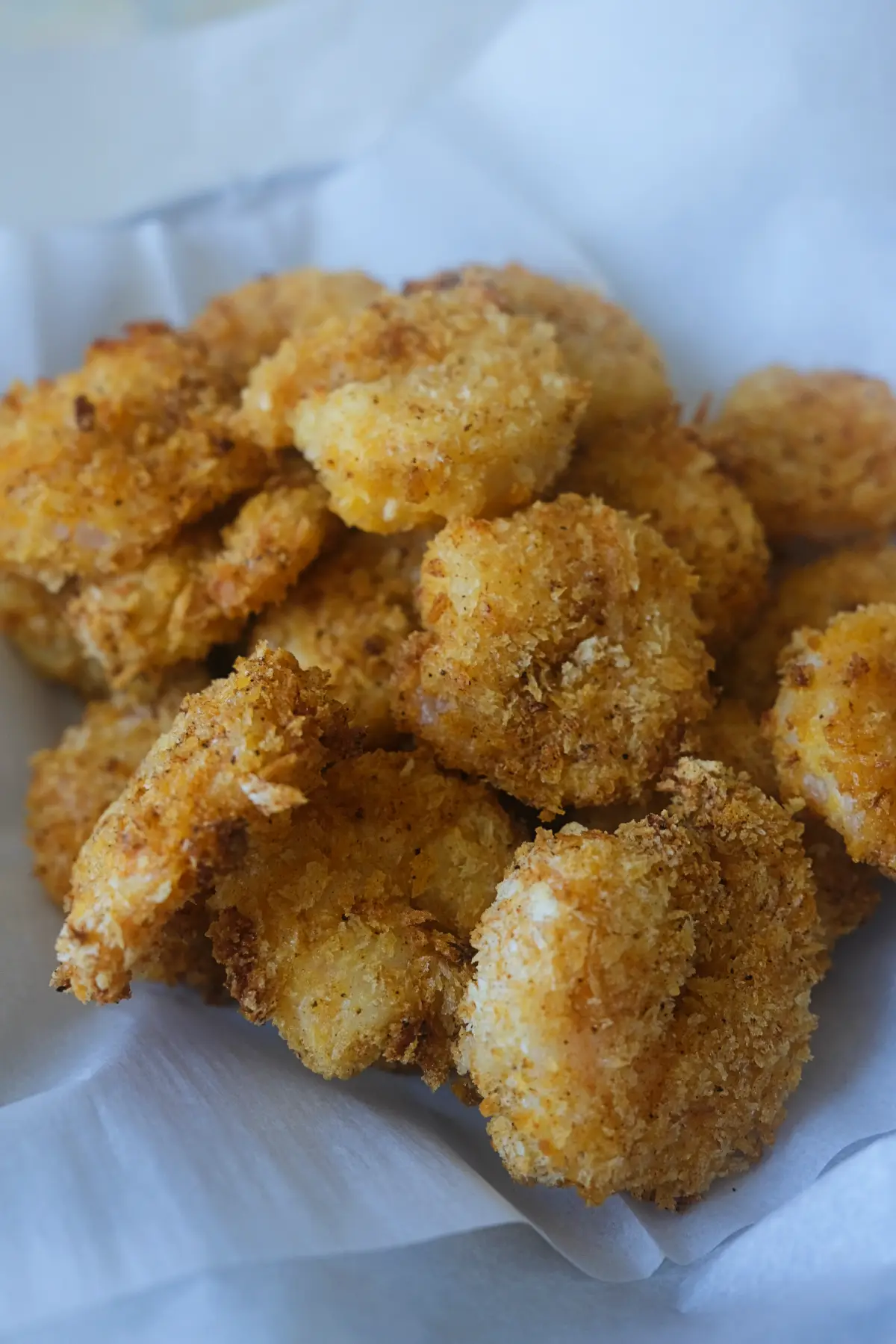 Crispy air fryer popcorn shrimp with golden panko coating served in a bowl