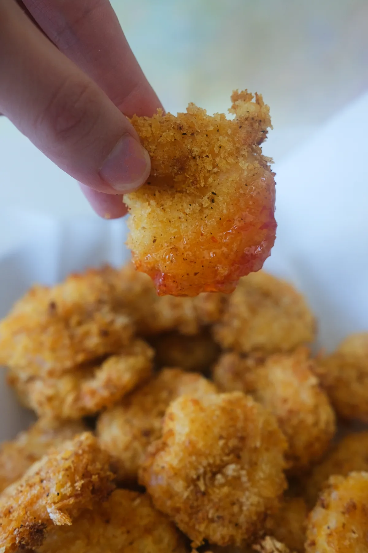 Close up of crunchy air fryer popcorn shrimp with sweet chili dipping sauce