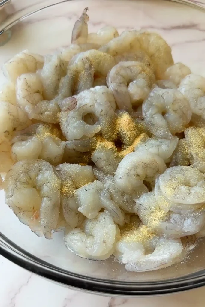 Raw shrimp seasoned with salt, pepper, garlic powder, and onion powder