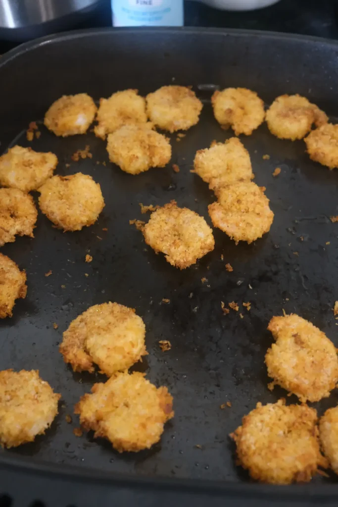 Finished air fryer popcorn shrimp with crispy golden panko breading
