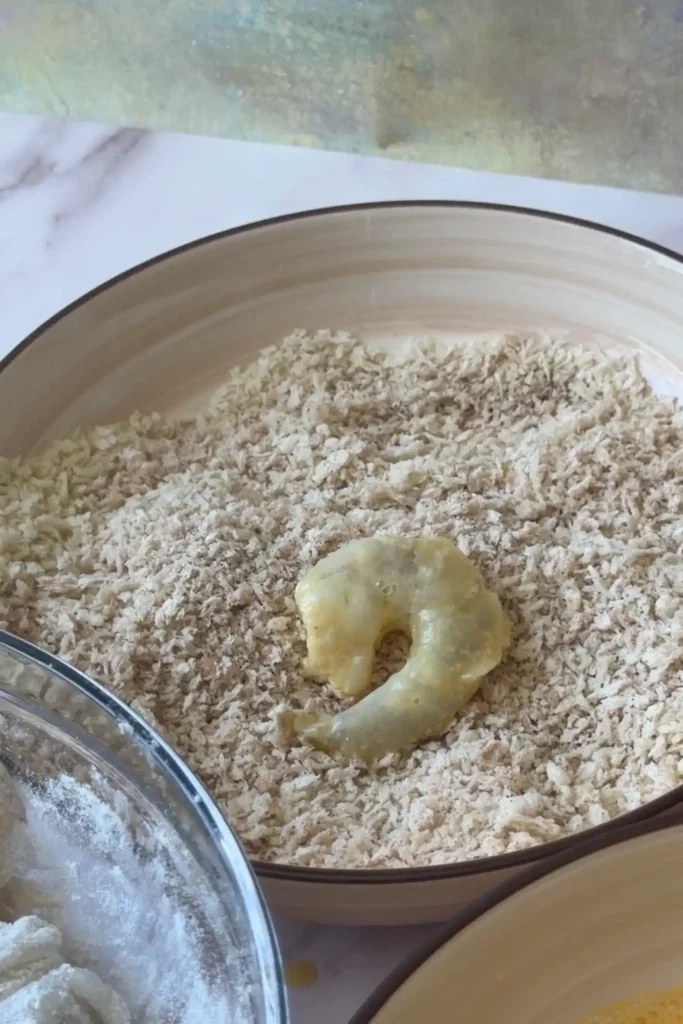 Shrimp coated in panko breadcrumbs before air frying until crispy and golden