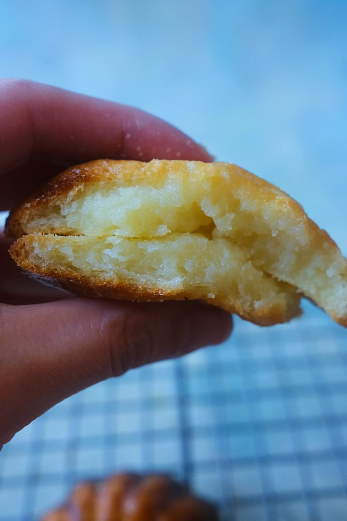 Cross-section of a butter tteok showing the soft, chewy center and crisp golden crust.