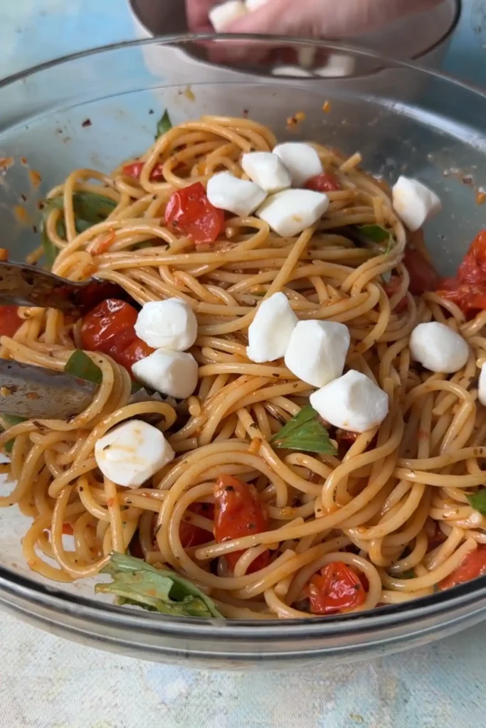 Fresh mozzarella pearls added to the Caprese pasta before gently tossing to combine.