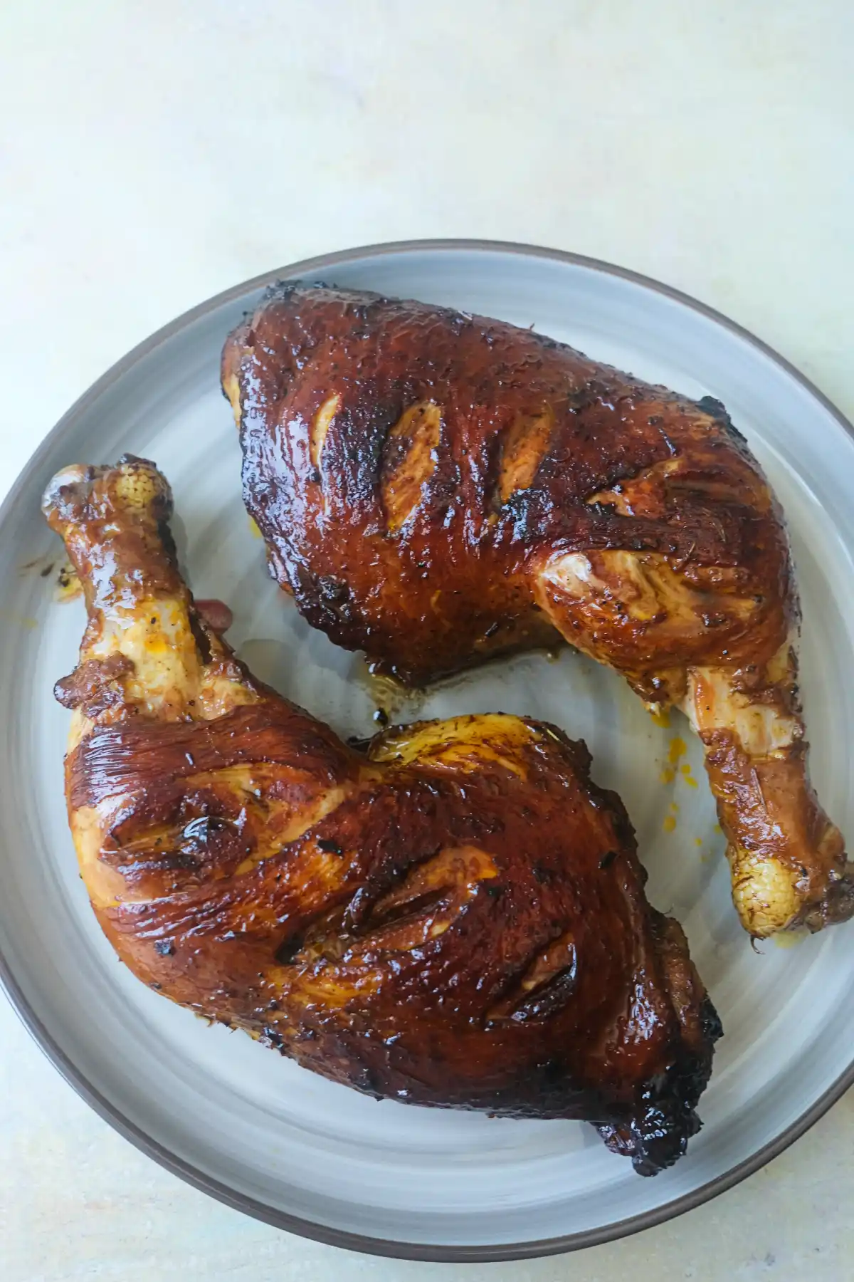 Chicken Inasal served on a plate with crispy golden skin and a flavorful soy and lemongrass marinade