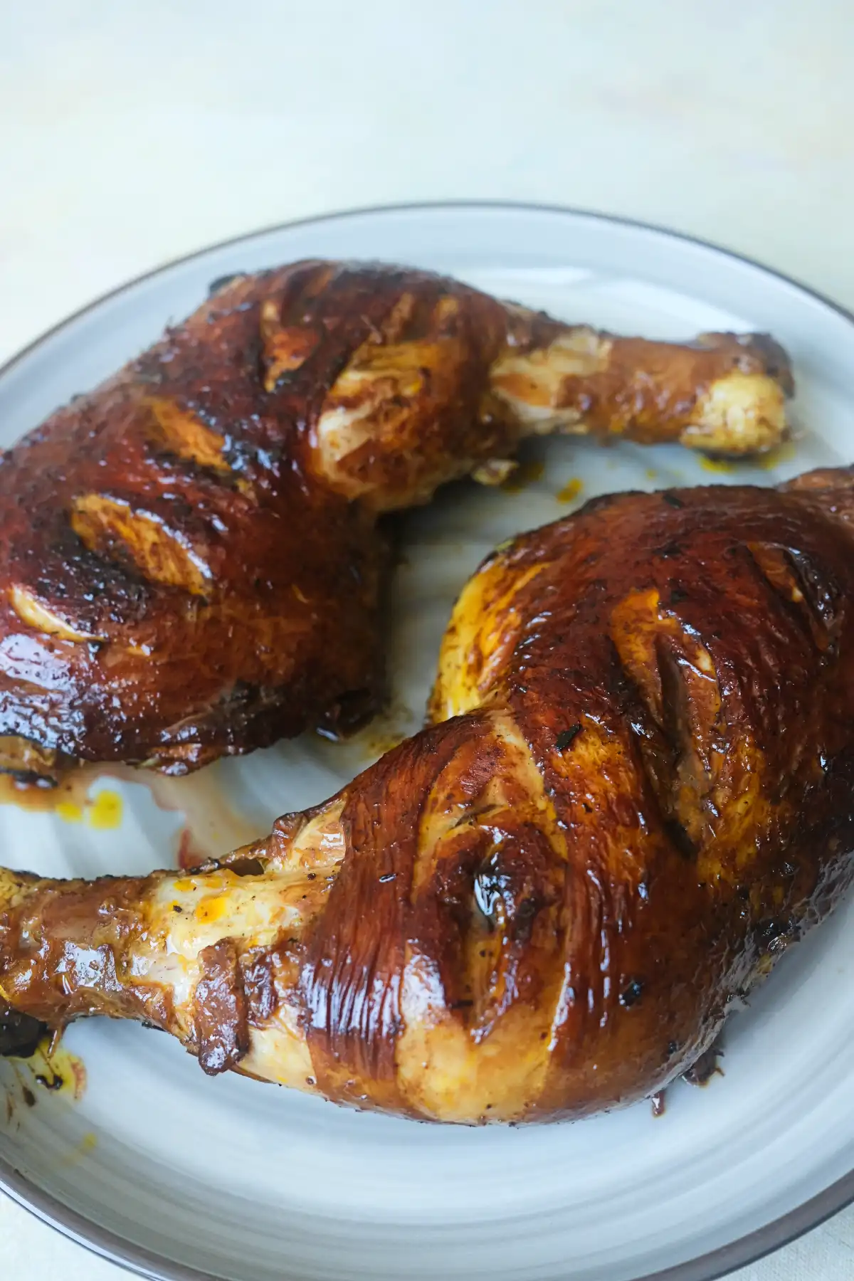 Juicy Filipino Chicken Inasal with glossy annatto oil brushed over crispy chicken skin