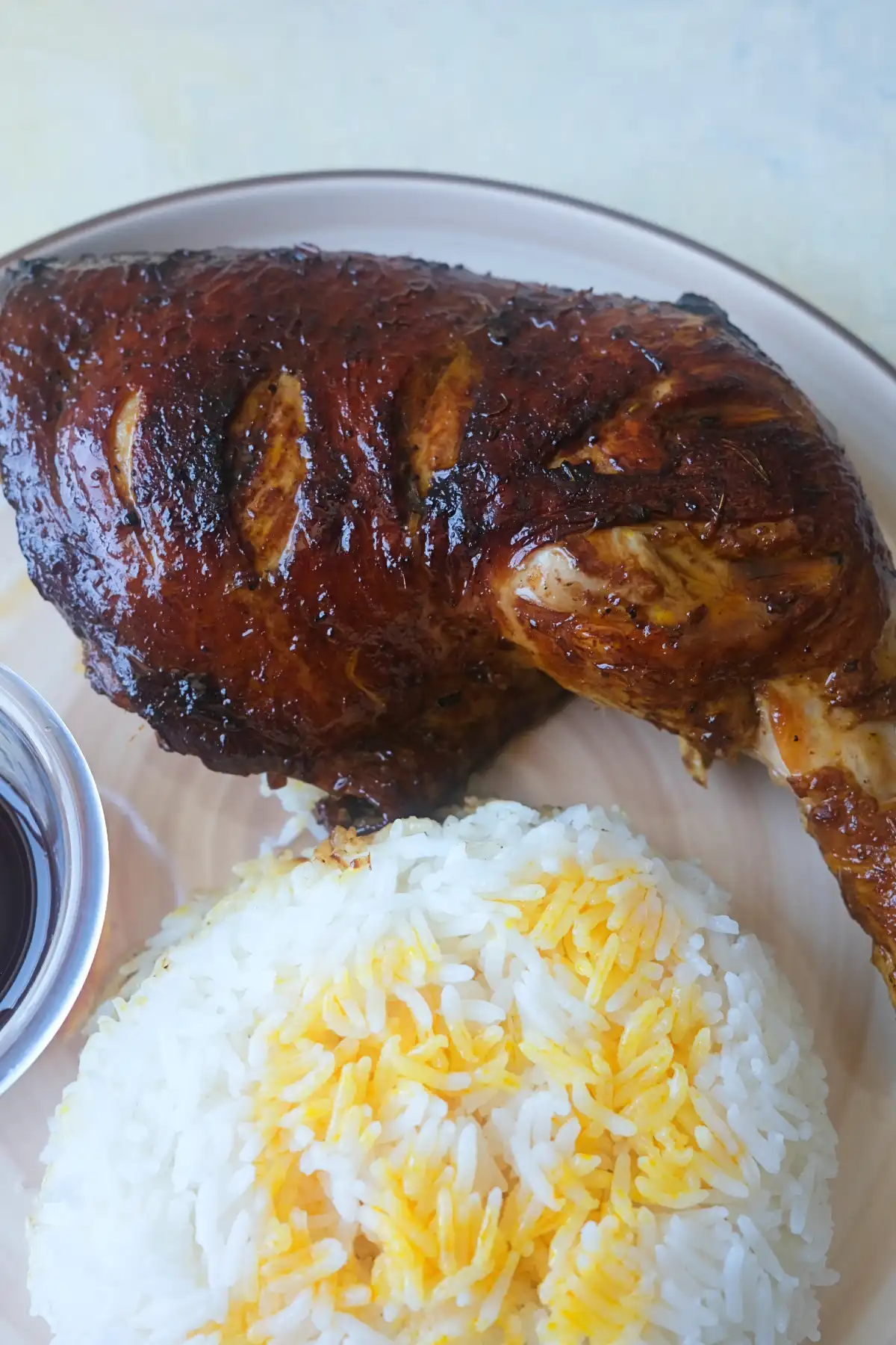 Chicken Inasal served with steamed rice, chicken oil, and soy calamansi dipping sauce