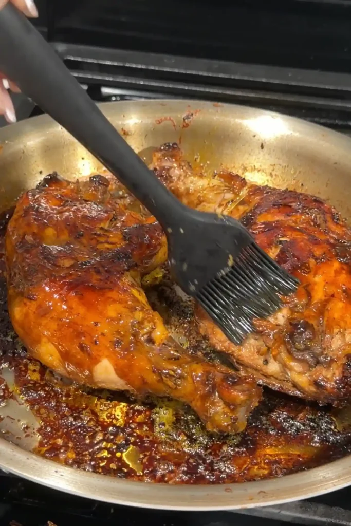 Chicken Inasal brushed with annatto oil while cooking for its signature color