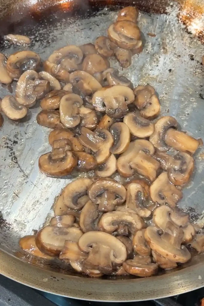 Sliced mushrooms sautéed in butter and beef drippings for mushroom gravy.