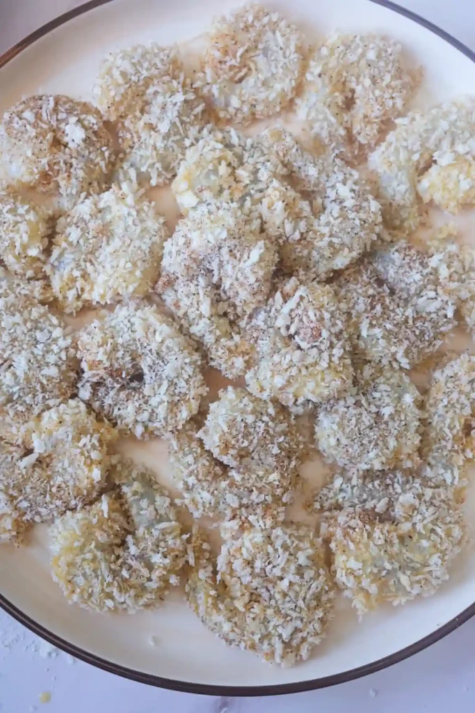 Shrimp coated with panko breadcrumbs before cooking in the air fryer