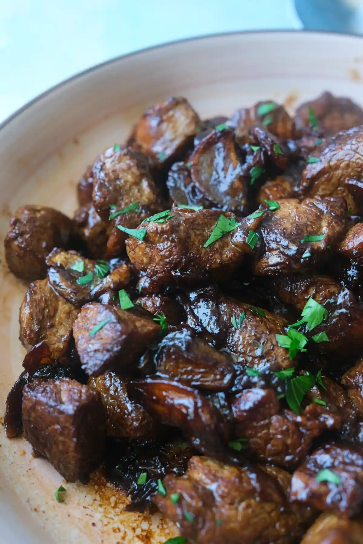 Pork salpicao with juicy pork loin, crispy garlic, and chopped parsley served in a shallow dish.