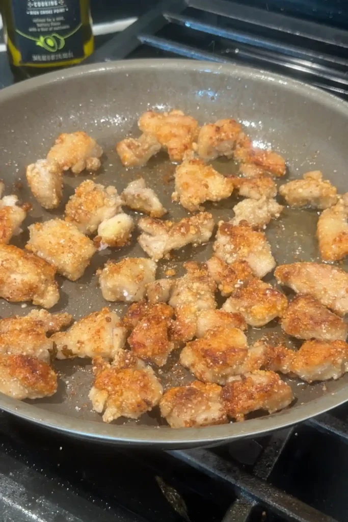 Taiwanese popcorn chicken frying until lightly golden in a skillet.