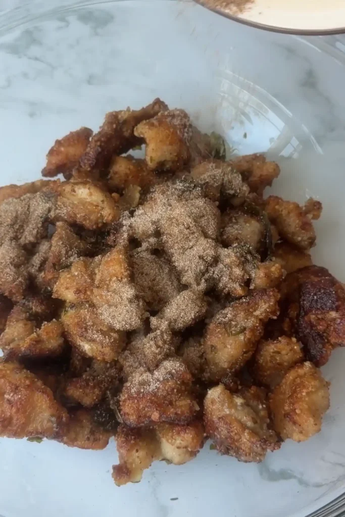 Five-spice seasoning sprinkled over freshly fried Taiwanese popcorn chicken.