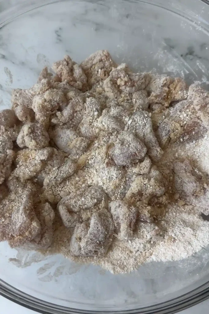 Marinated chicken coated in sweet potato starch before frying.