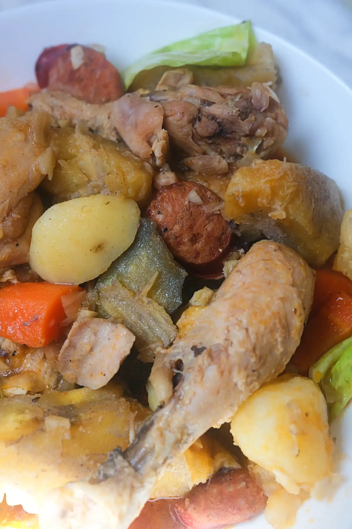 Chicken pochero with chorizo, saba bananas, potatoes, carrots, eggplant, and cabbage