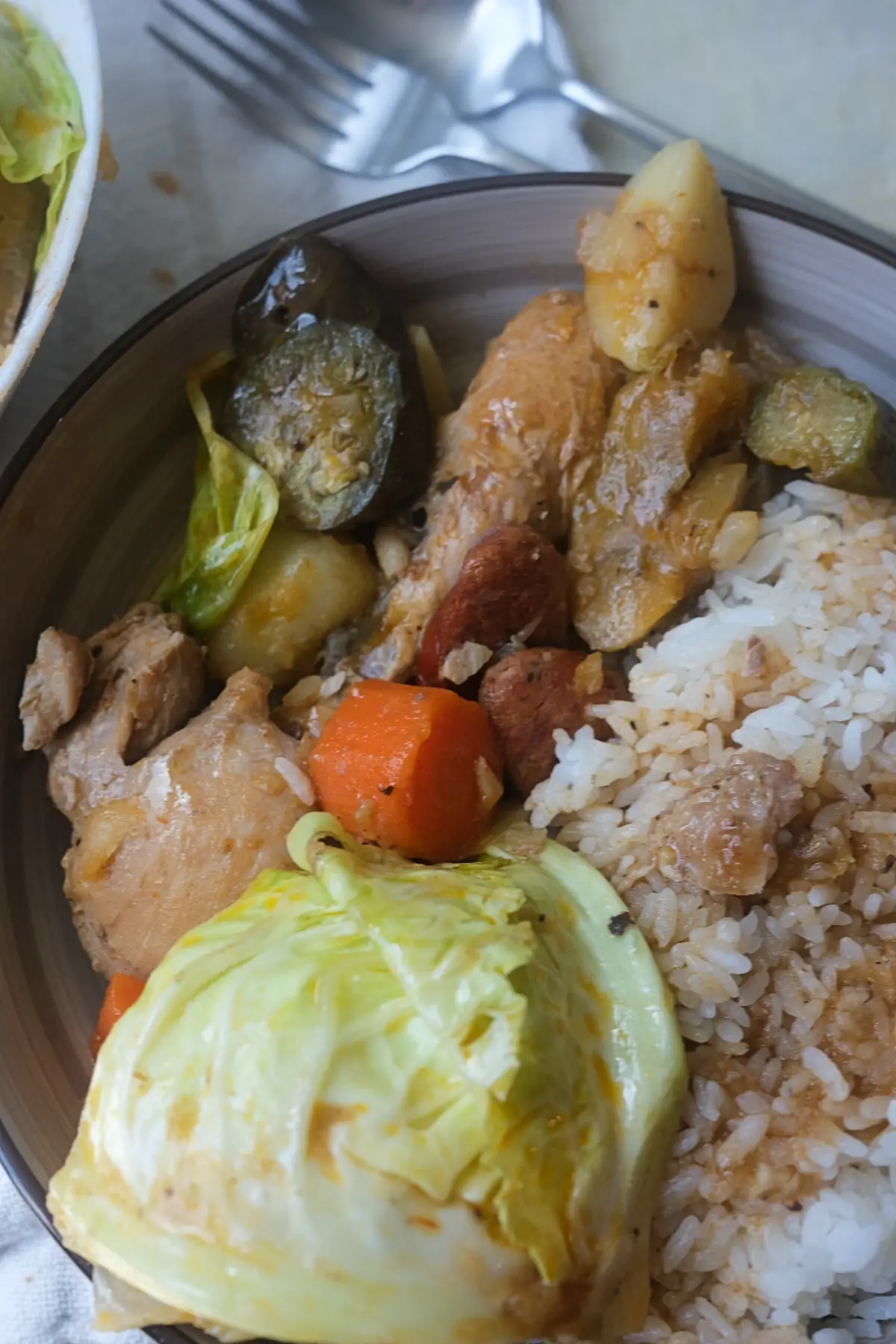Filipino chicken pochero served with steamed white rice and vegetables