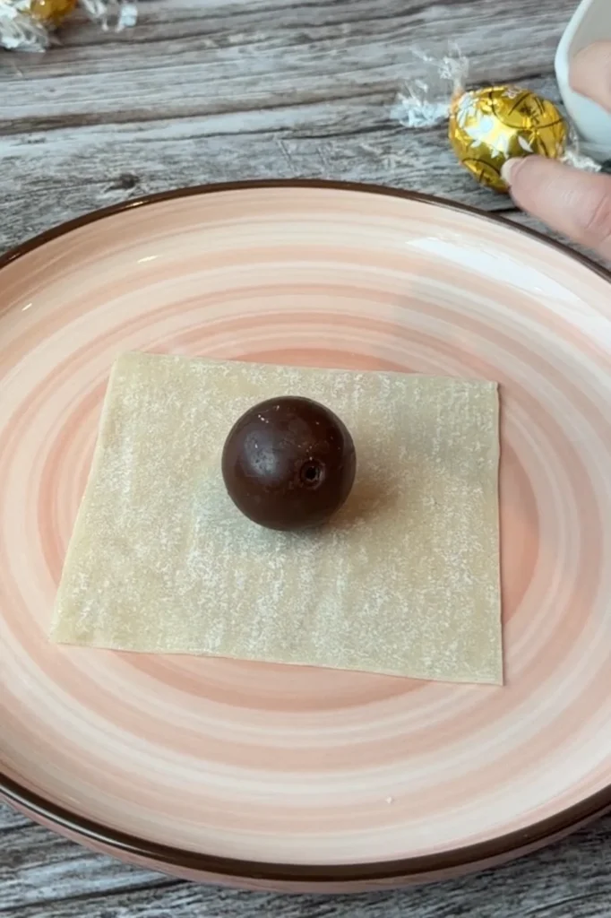 Lindt chocolate truffle placed in the center of a wonton wrapper before folding into a chocolate dumpling.