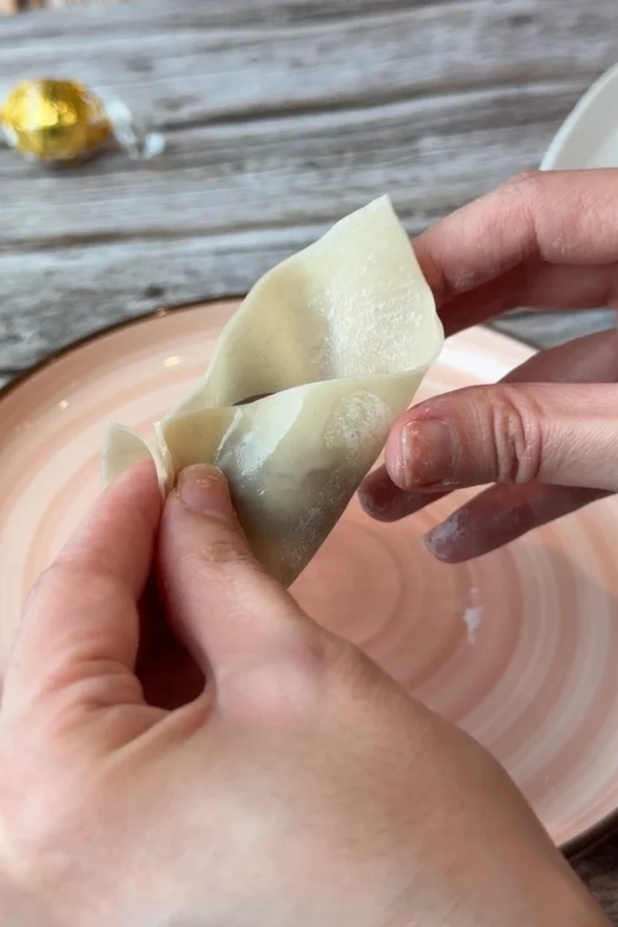 Lindt chocolate truffle placed in the center of a wonton wrapper before folding into a chocolate dumpling.