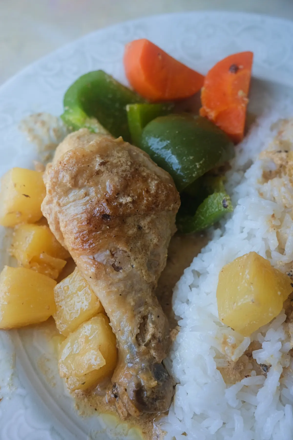 Pininyahang Manok with chicken, pineapple chunks, carrots, and green bell peppers served with steamed rice.