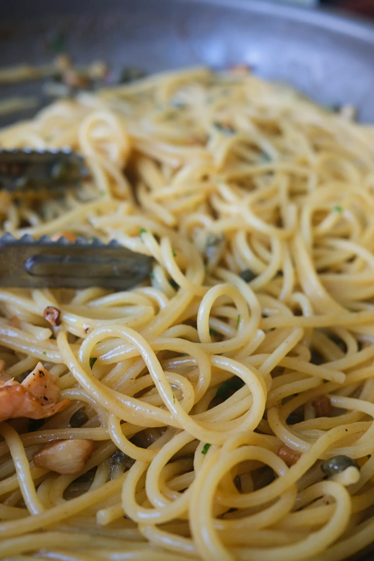 Spaghetti coated in lemon butter piccata sauce with capers and fresh parsley.